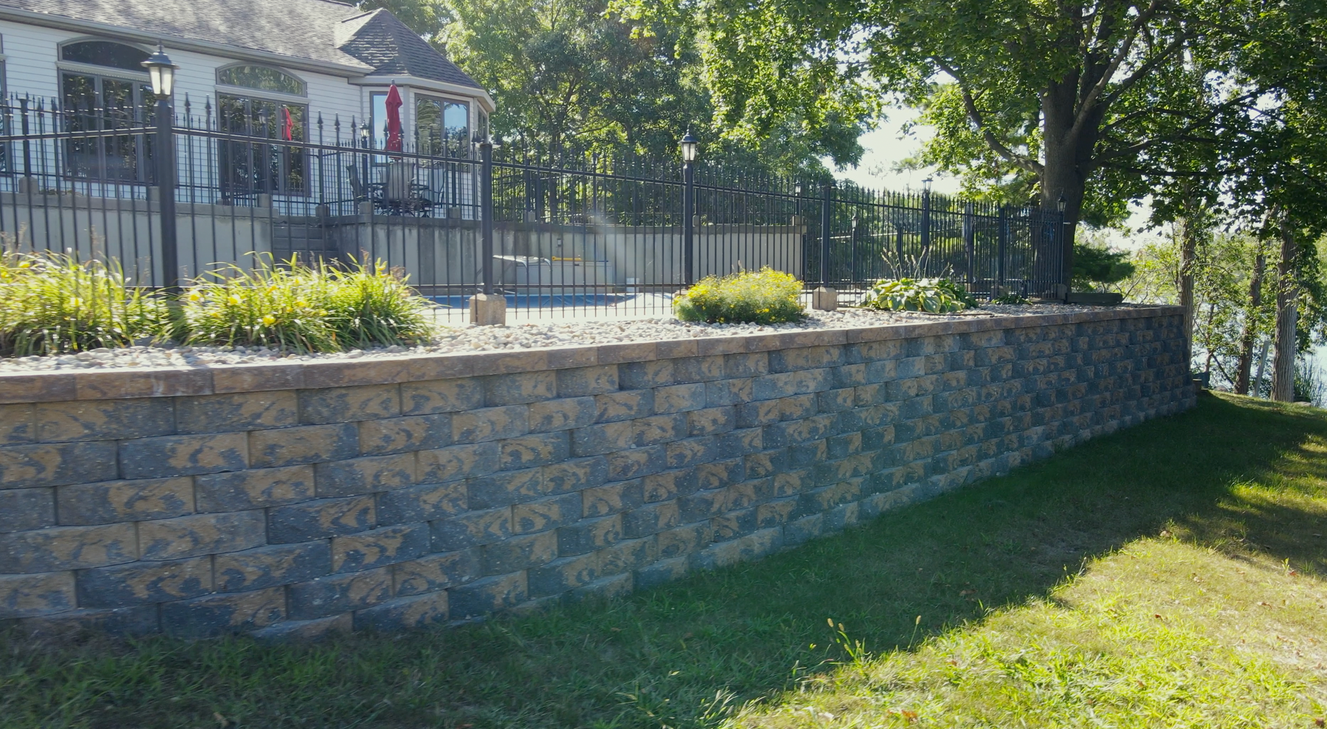 An aerial view of a patio with a table and chairs and a grill.