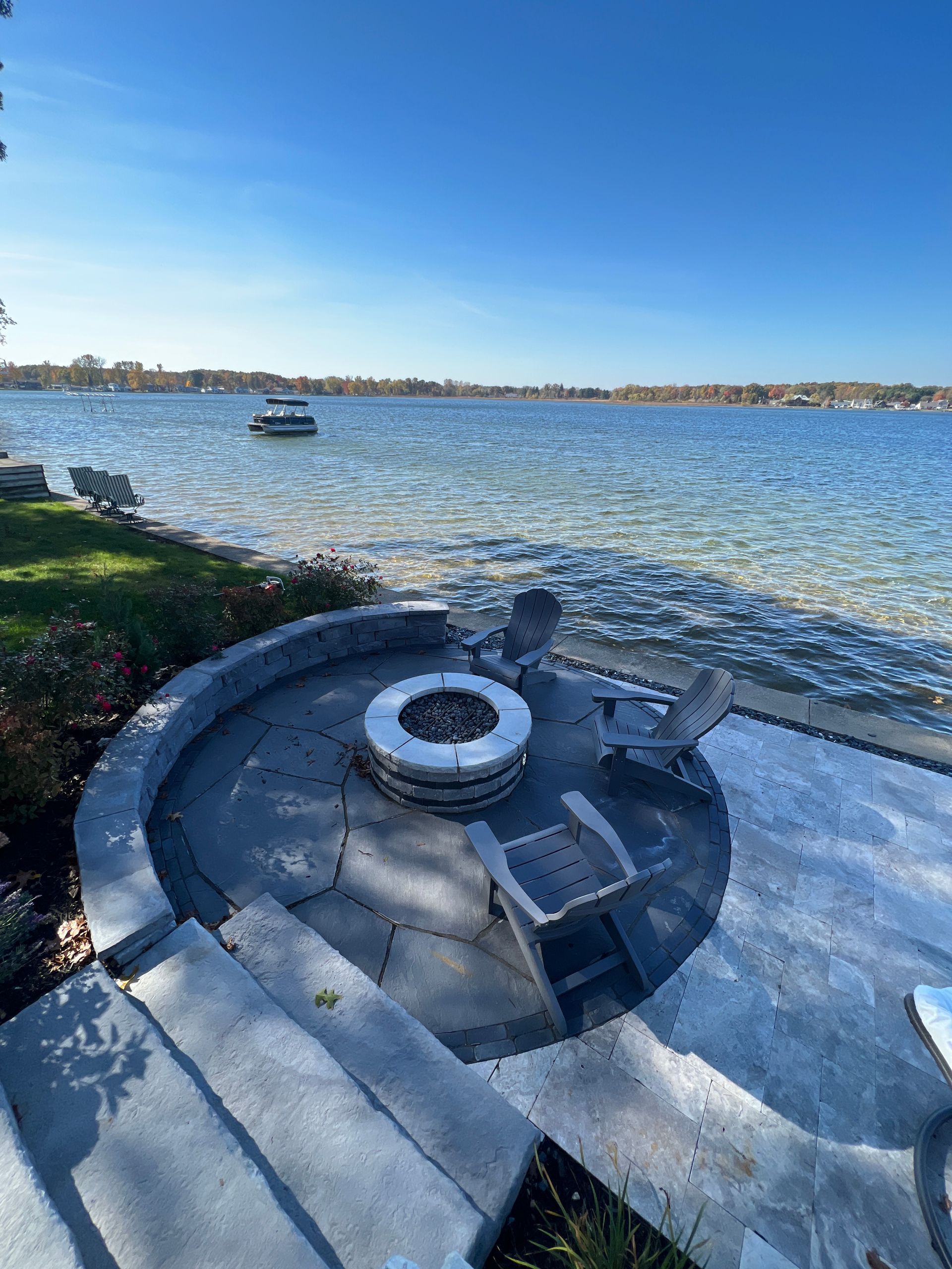 An aerial view of a patio with a table and chairs and a grill.