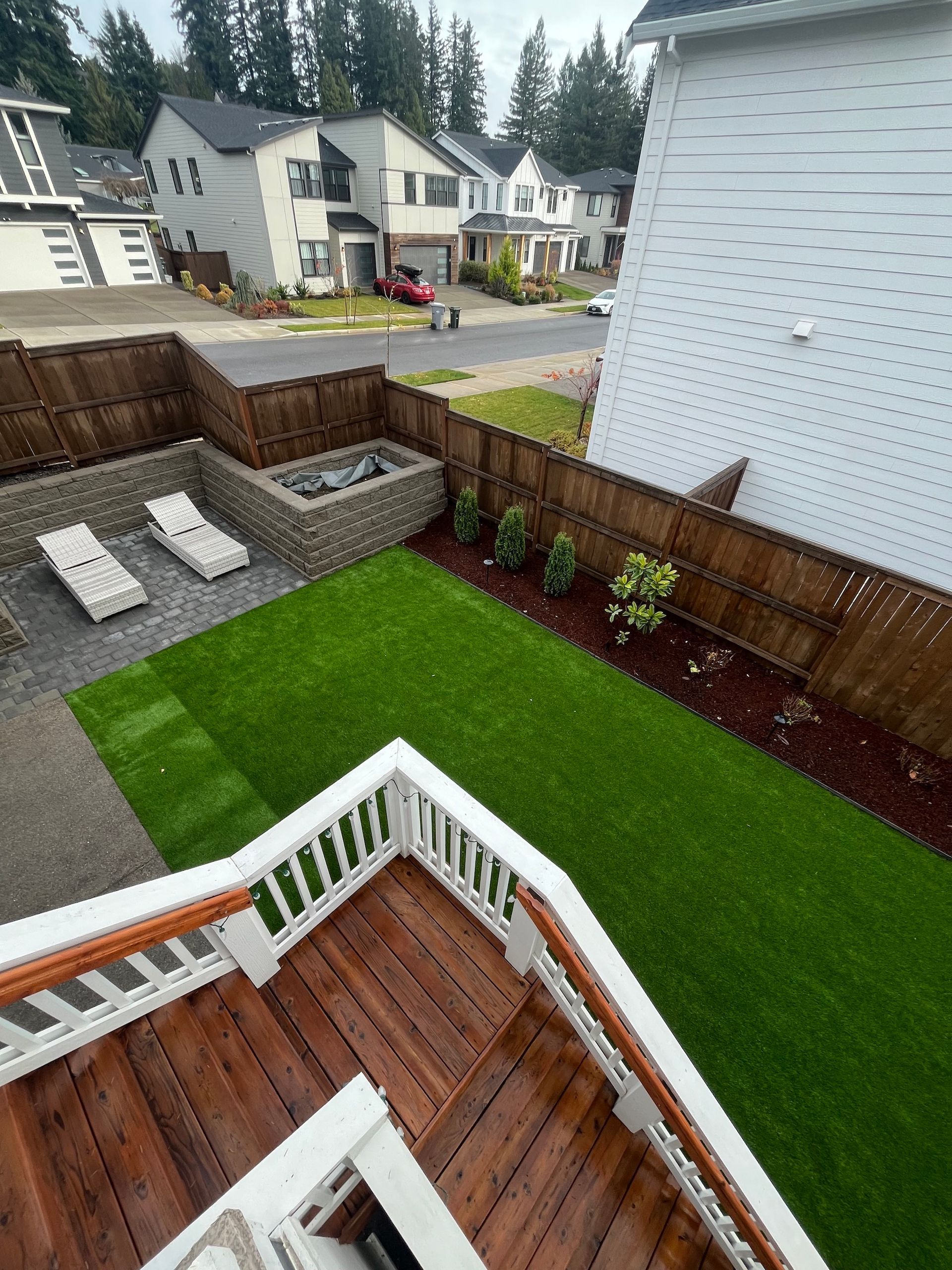 An aerial view of a backyard with pavers and fresh sod.