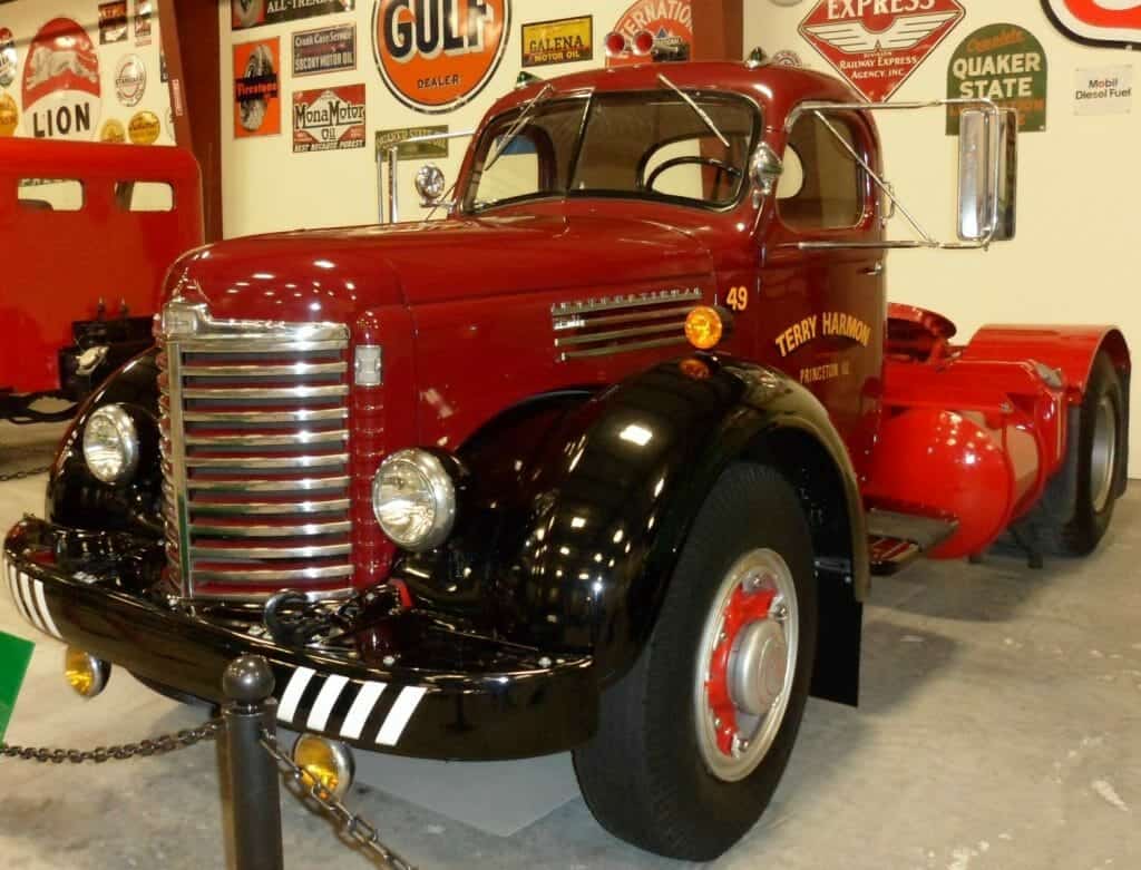A red truck with a gulf sign on the wall behind it