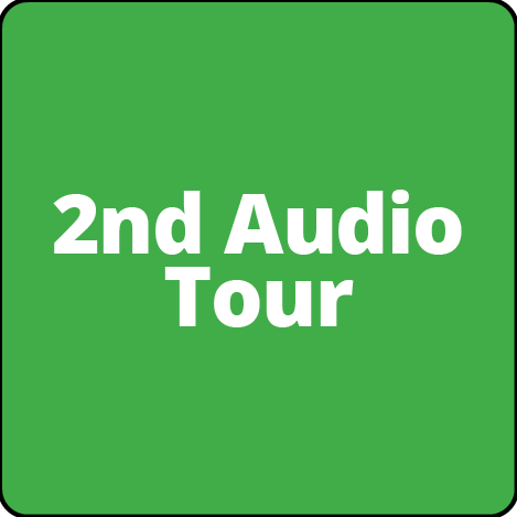 A green square with the words `` 2nd audio tour '' written on it.