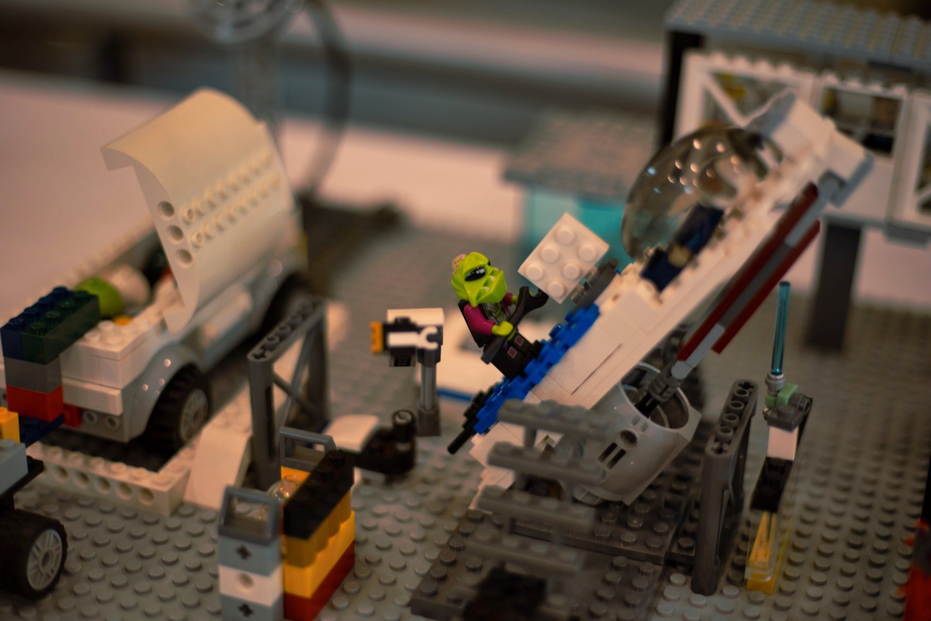 A lego model of an airplane is being built on a table.