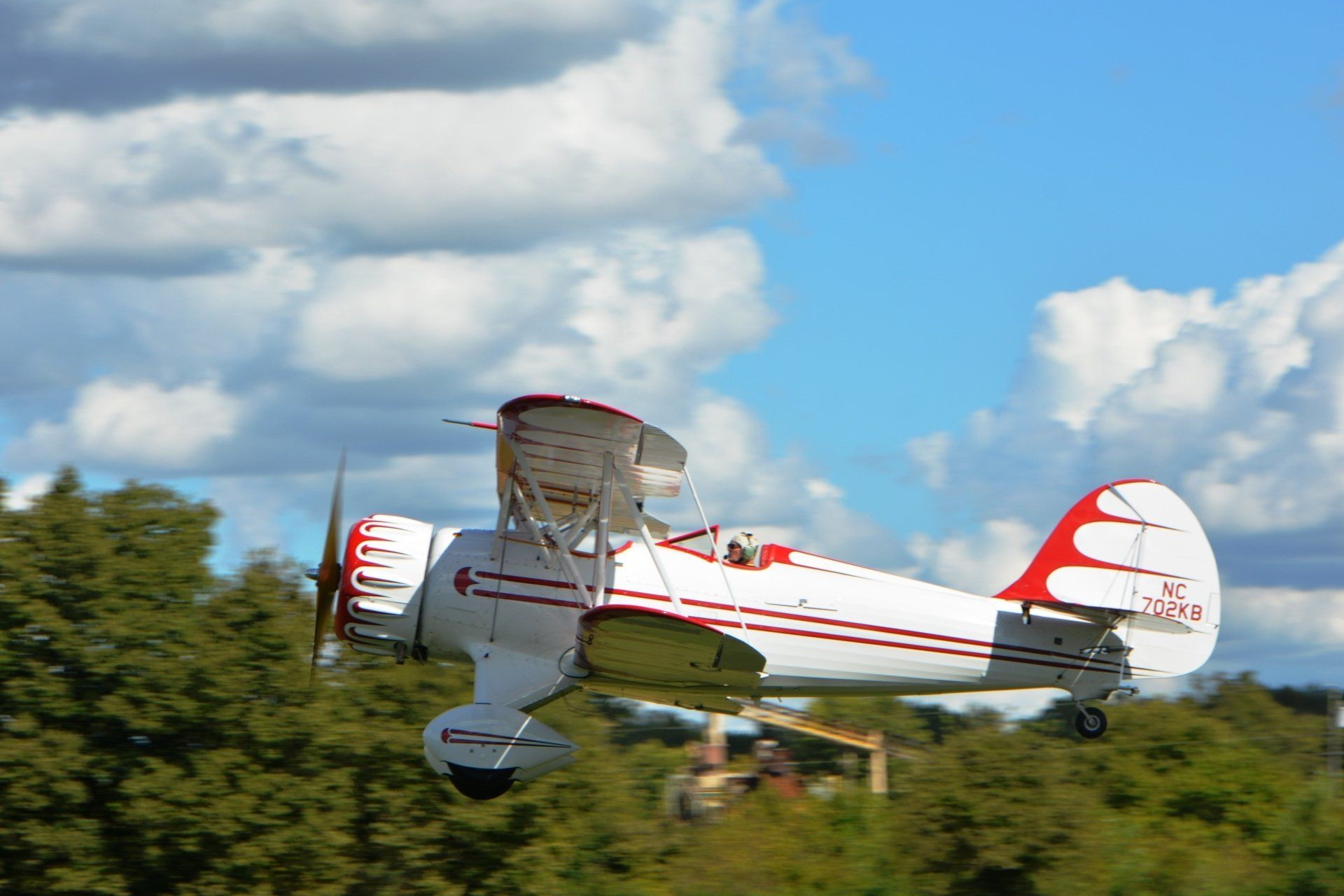 A white and red airplane is flying in the sky