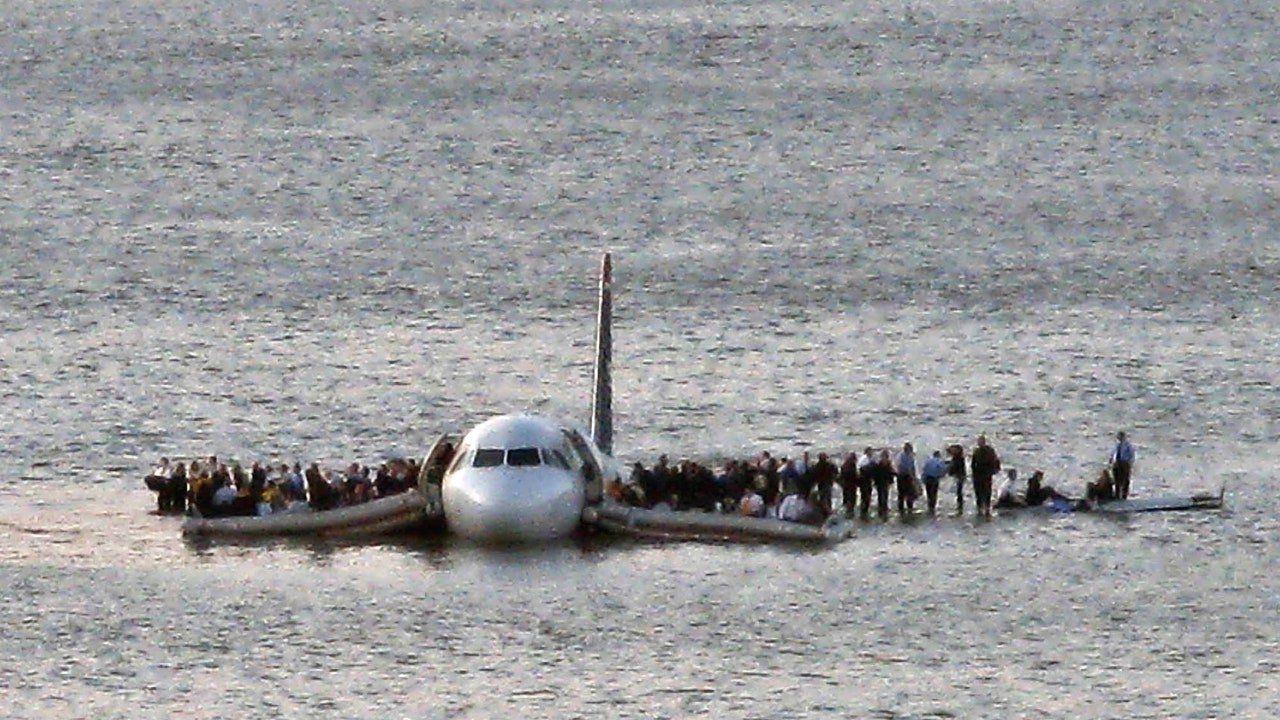 A plane is floating on its side in the water