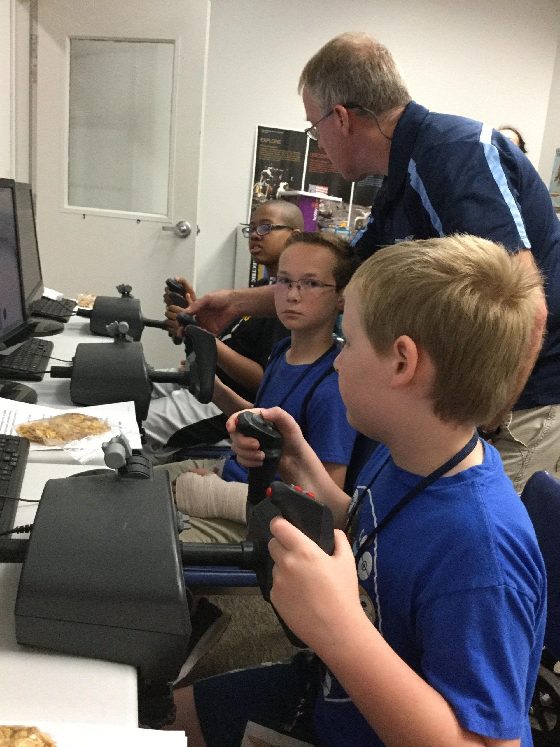 A group of children are playing a video game on a computer.
