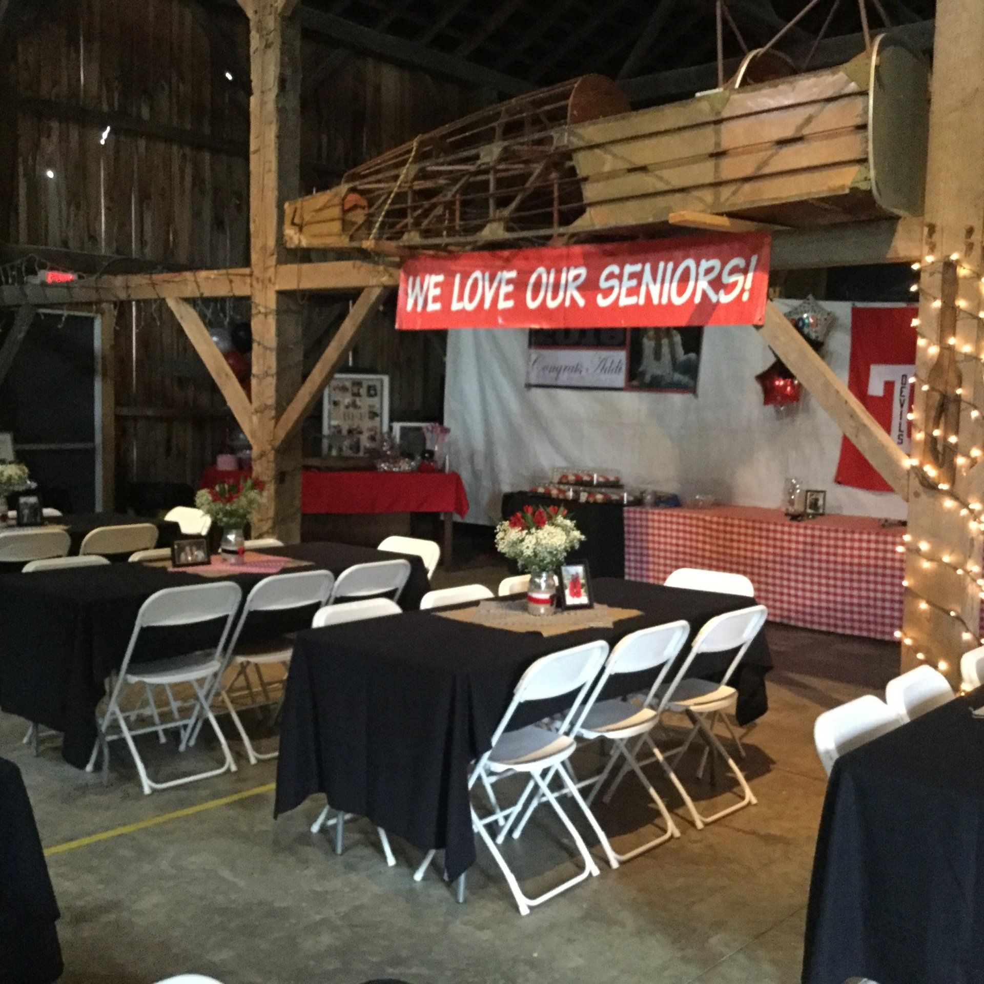 A sign that says we love our seniors hangs above tables and chairs