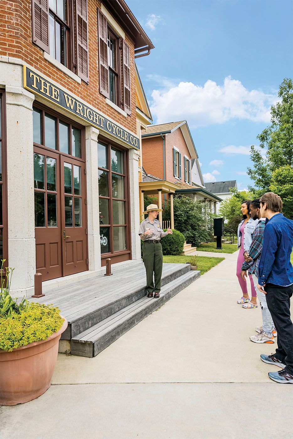 A group of people are standing outside of a building.