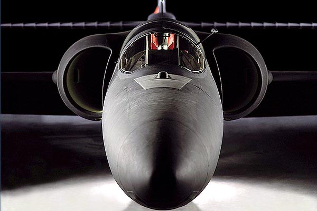 A close up of a fighter jet with a pilot in the cockpit