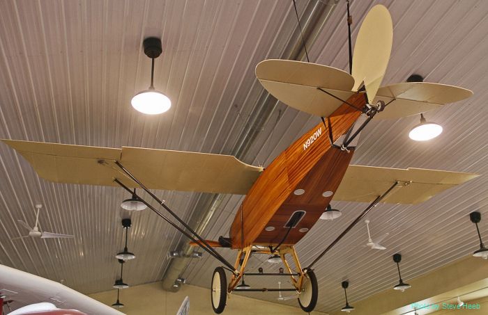 A model airplane is hanging from the ceiling of a building
