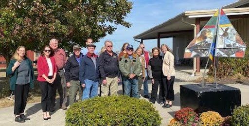 A group of people are standing in front of a building.