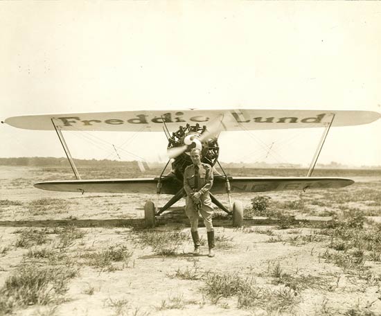 A man stands in front of a freddie lund plane