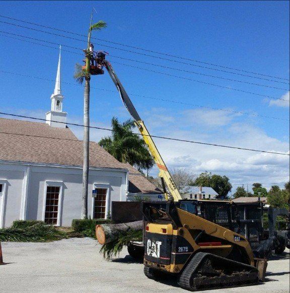 A cat truck is parked in front of a church