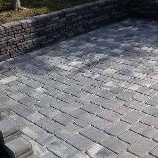 A brick walkway with a brick wall in the background