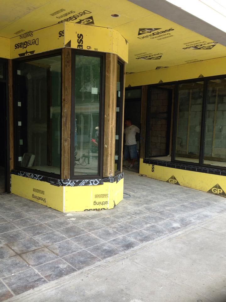Newly Installed Glass In Yellow Building — Marathon, FL — All Keys Glass Inc