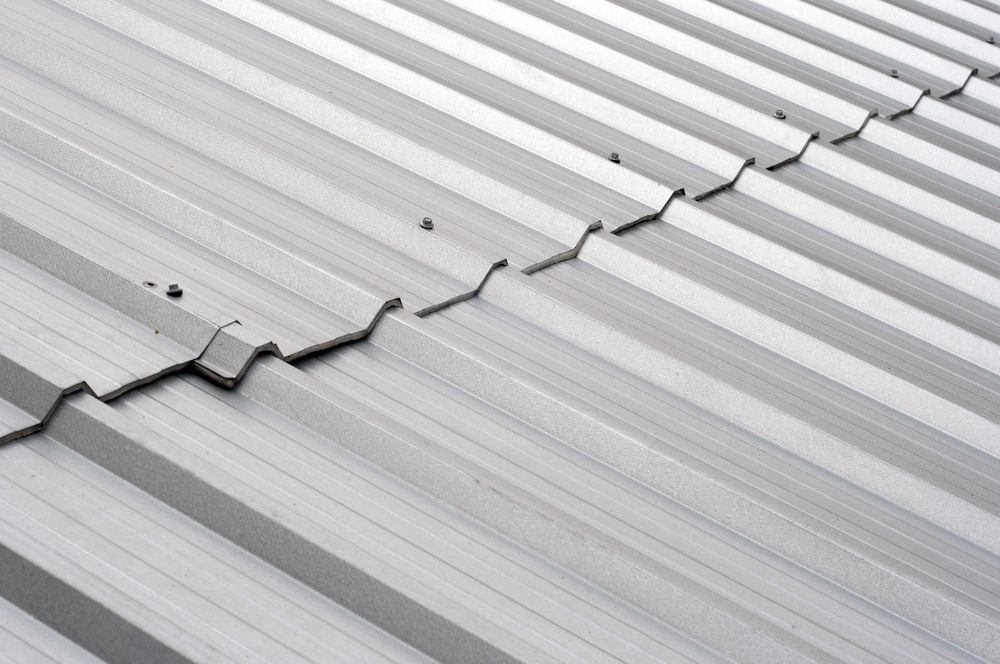 Close-up of a corrugated metal roof, grey with a ridged pattern — JLH Plumbing, Gas & Roofing in South Nowra, NSW