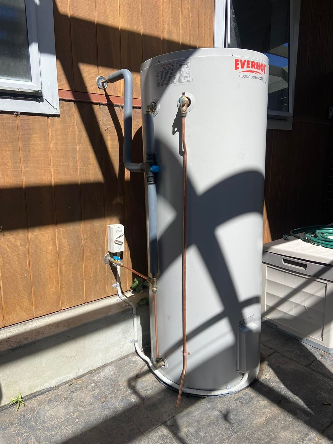 Vertical Water Heater Mounted on a Wall — JLH Plumbing, Gas & Roofing in South Nowra, NSW