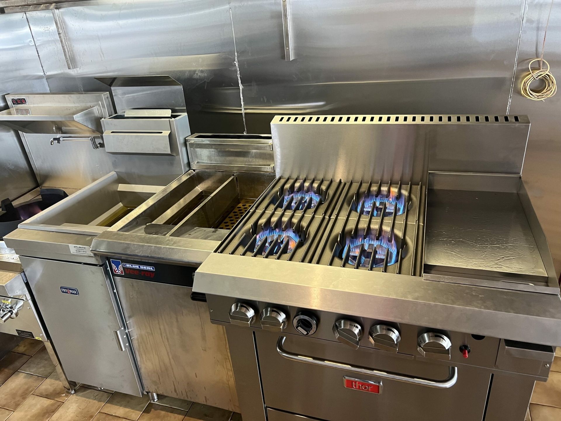 Stainless Steel Commercial Kitchen Stove — JLH Plumbing, Gas & Roofing in South Nowra, NSW
