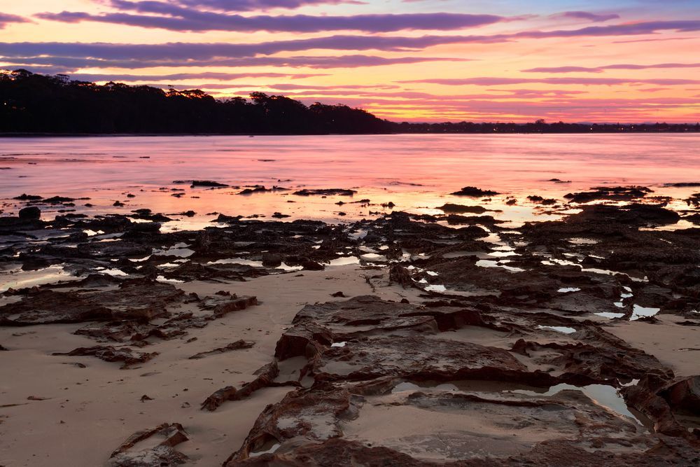 Sunset Over a Rocky Shoreline — JLH Plumbing, Gas & Roofing in Vincentia, NSW