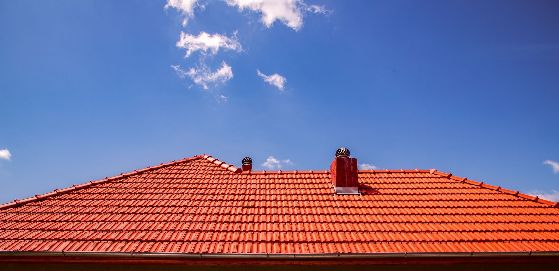 A Red Tiled Roof with Two Whirlybirds — JLH Plumbing, Gas & Roofing in Kiama, NSW