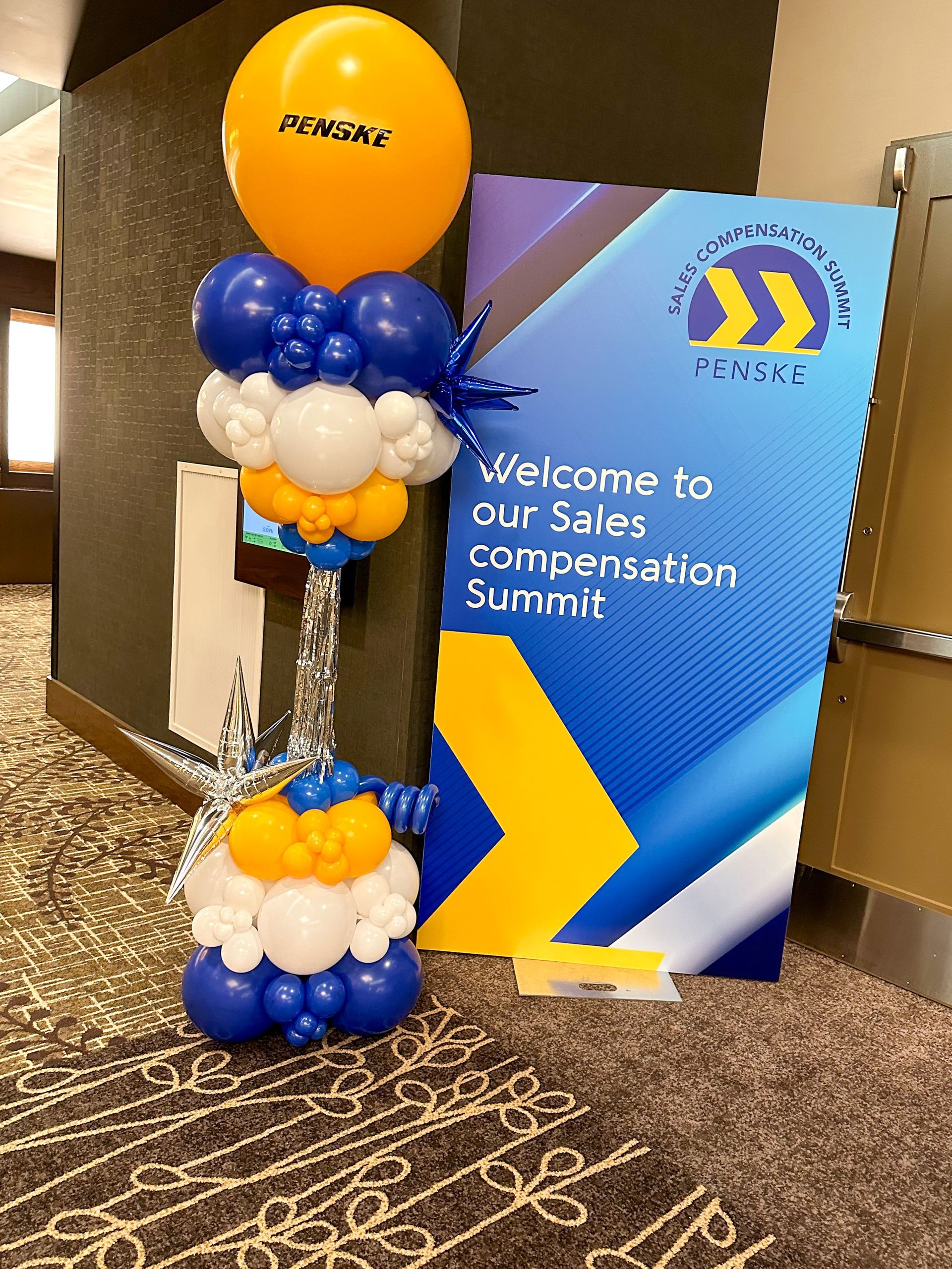 A sign that says welcome to our sales compensation summit