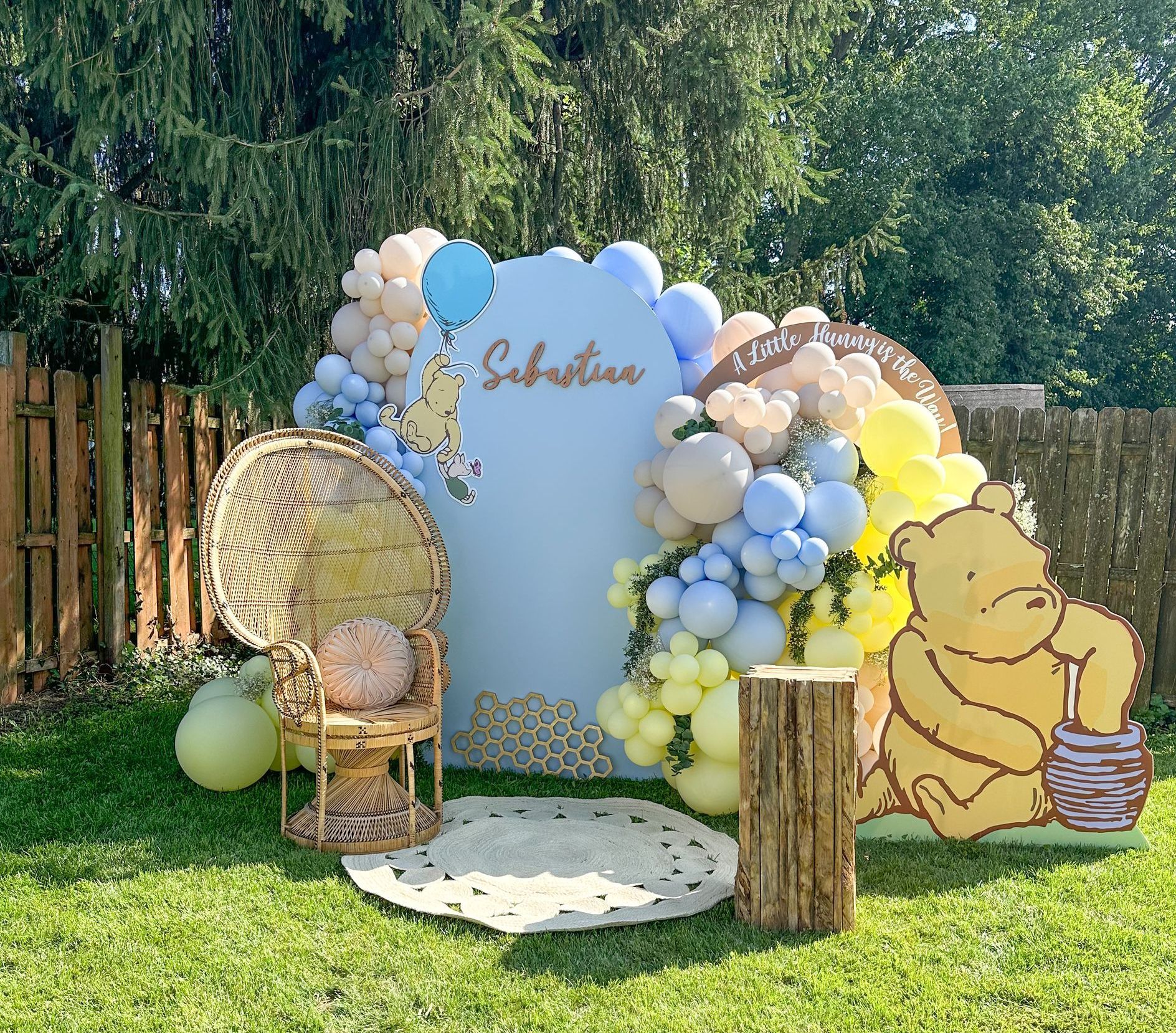 A room filled with balloons and a cake on a table.