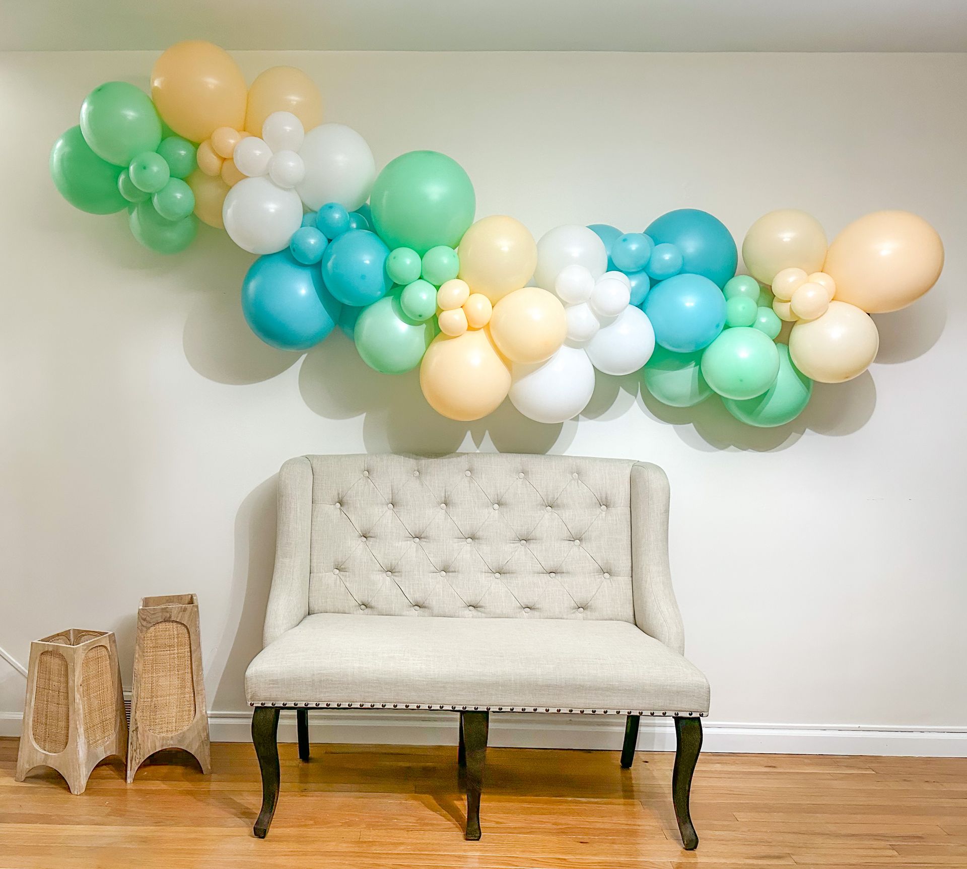 A room with a couch and balloons on the wall