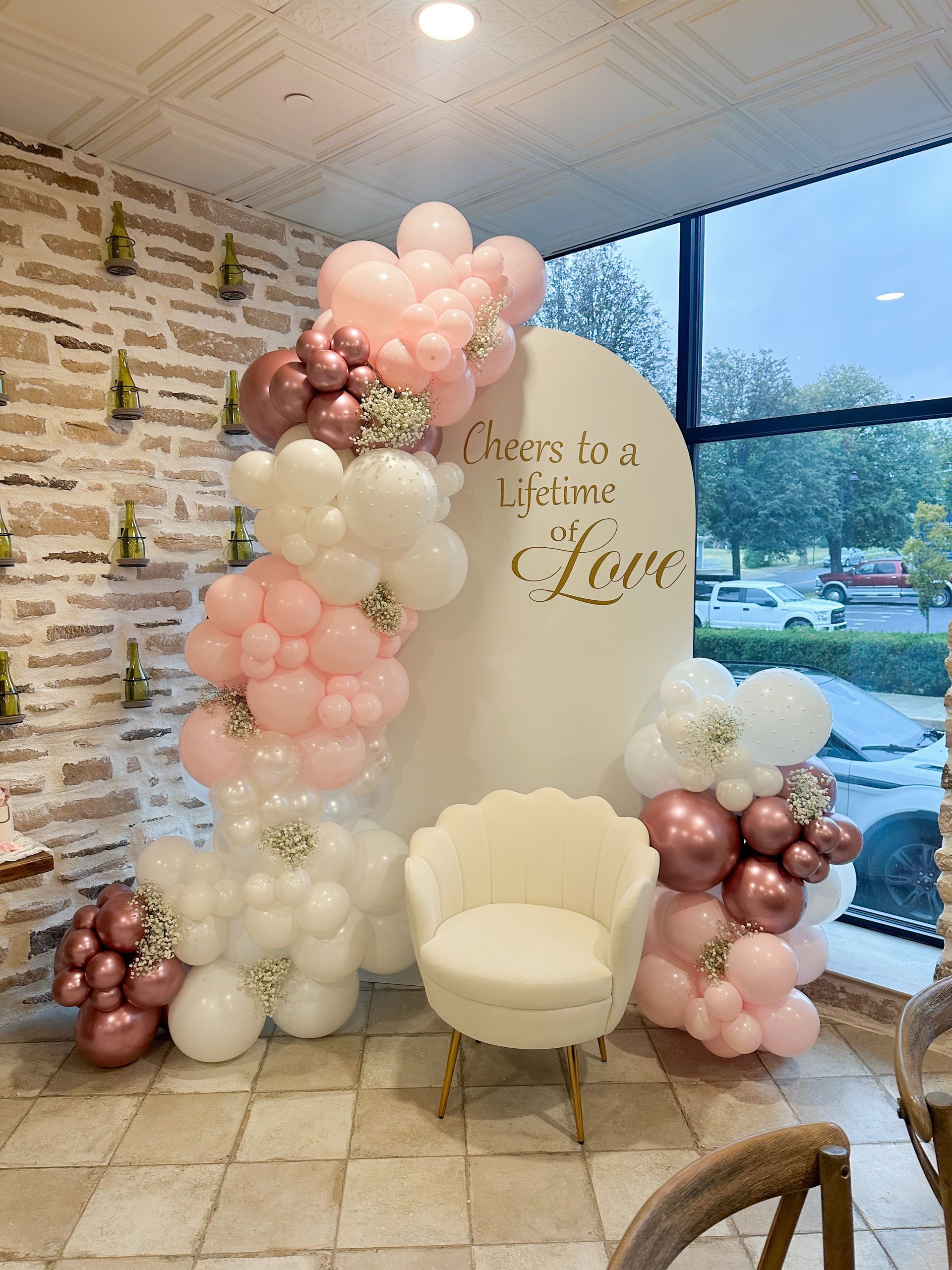 A room decorated with pink and white balloons for a bridal shower