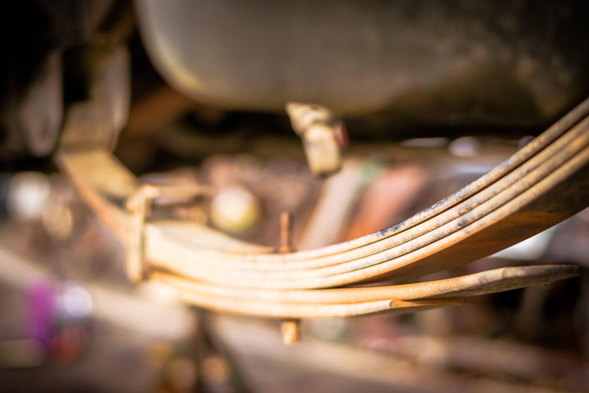 A close up of a leaf spring on a car.