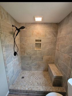 A bathroom with a walk in shower and a toilet.