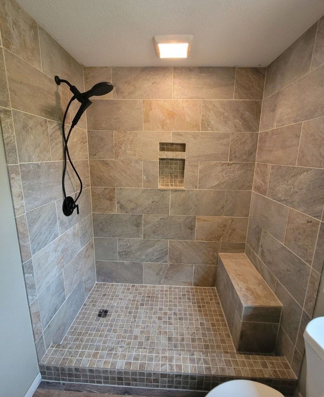 A bathroom with a walk in shower and a toilet.