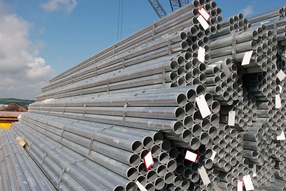 A Pile Of Metal Pipes Stacked On Top Of Each Other — Fullerton's Plumbing Manufacture In Woree, QLD