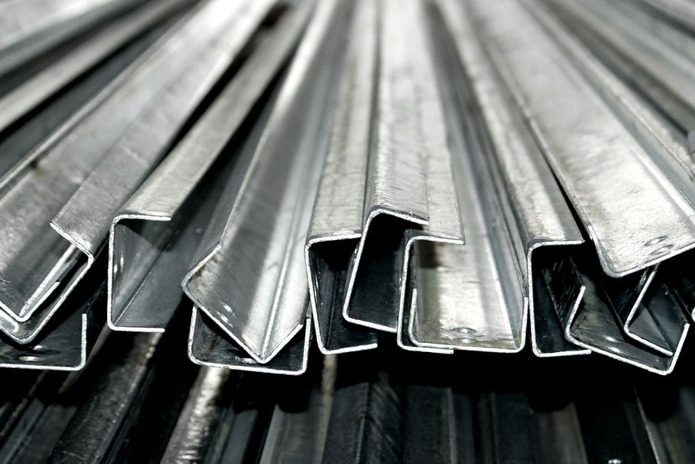 A Close Up Of A Metal Roof With A Gutter On It — Fullerton's Plumbing Manufacture In Woree, QLD