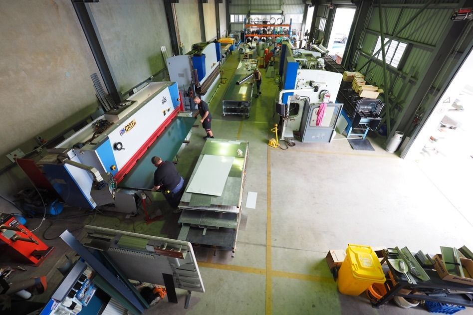 An Aerial View Of A Factory With People Working On Machinery — Fullerton's Plumbing Manufacture In Woree, QLD