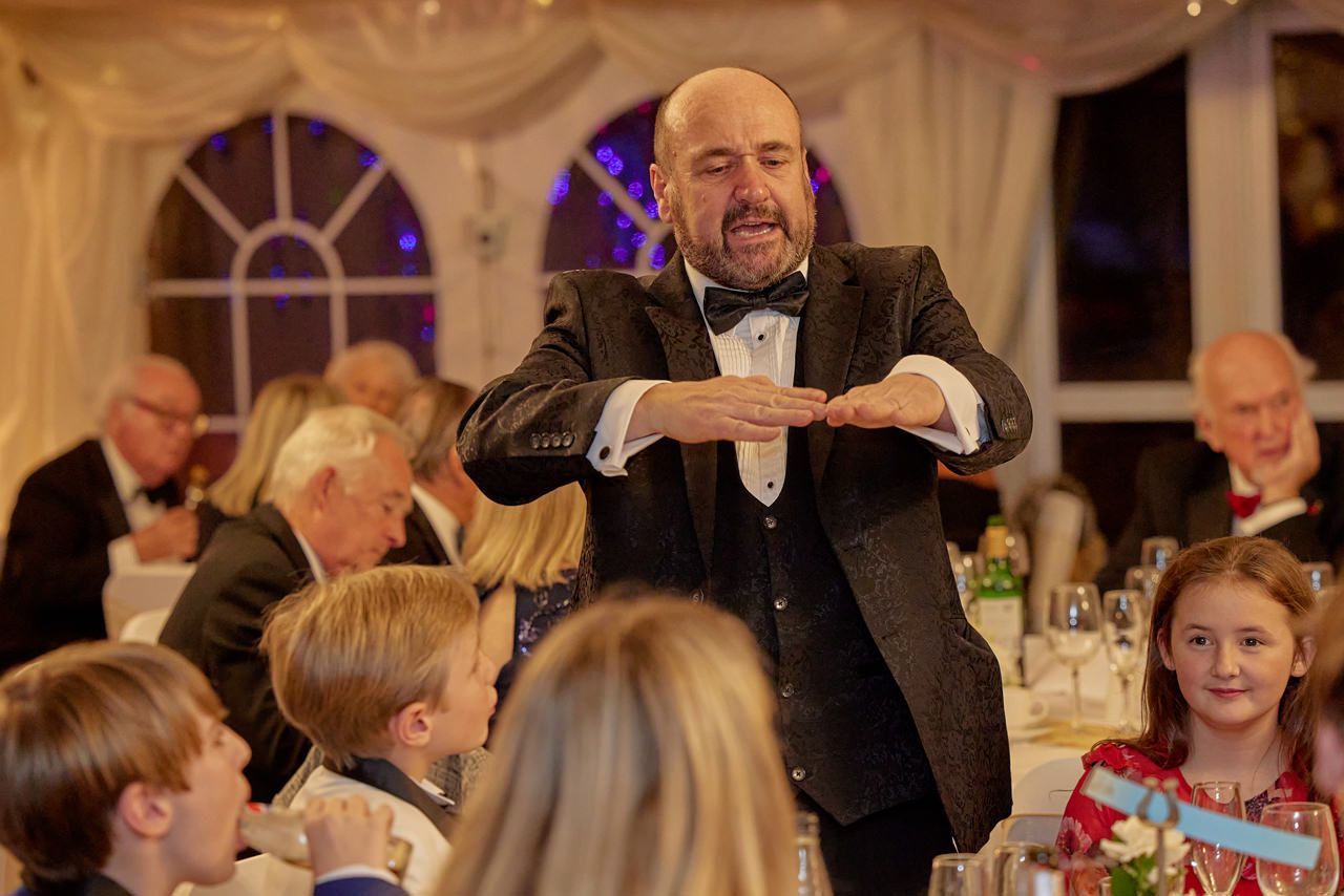 Wedding Magician Paul Roberts entertains a group of people at a Liverpool wedding.