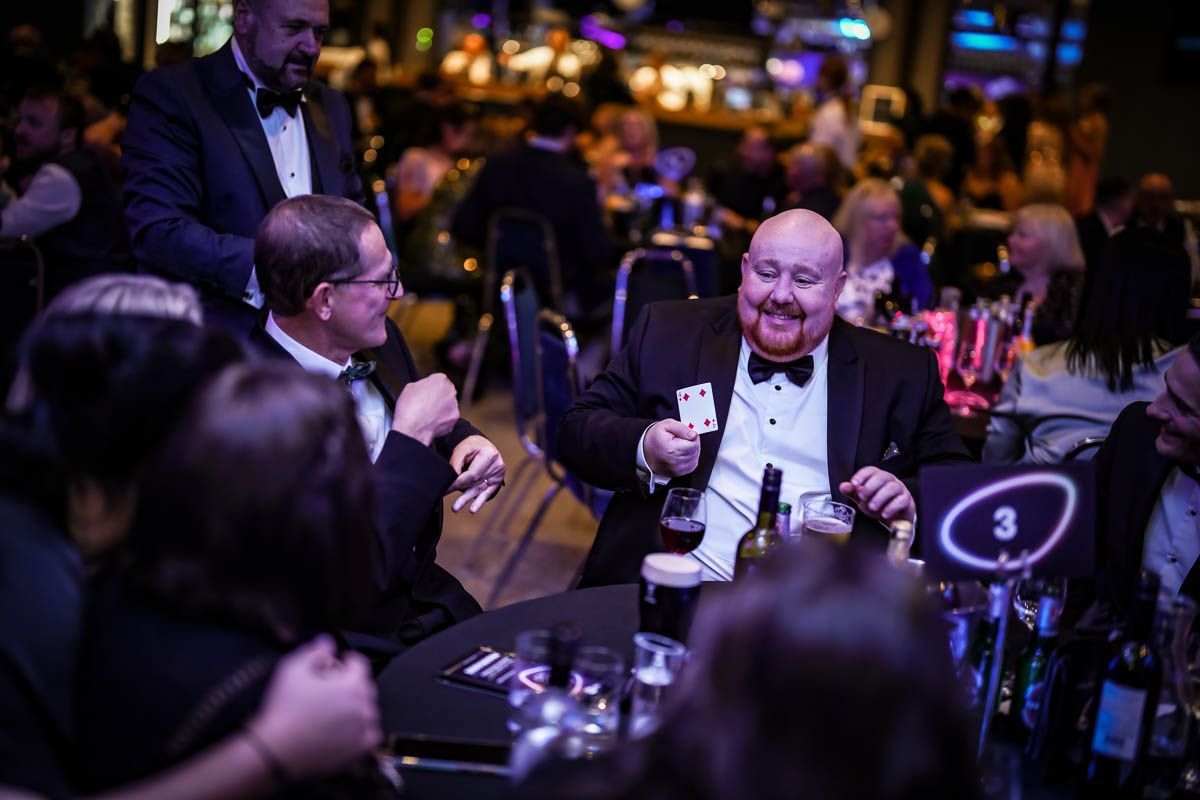 Paul Roberts, a professional magician, captivates the audience with a stunning magic trick during a live performance in Liverpool.