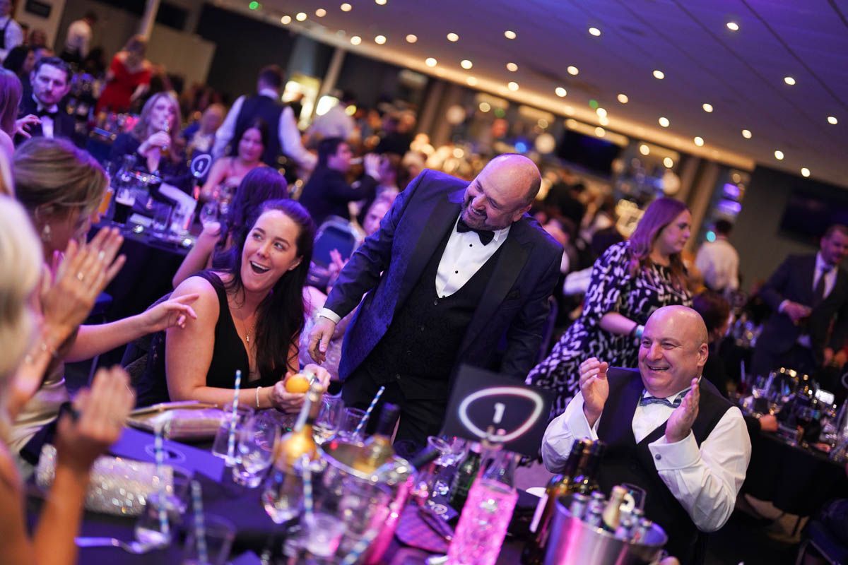 Close up Magician Paul Roberts performing to guests at an event in Liverpool, guests laughing