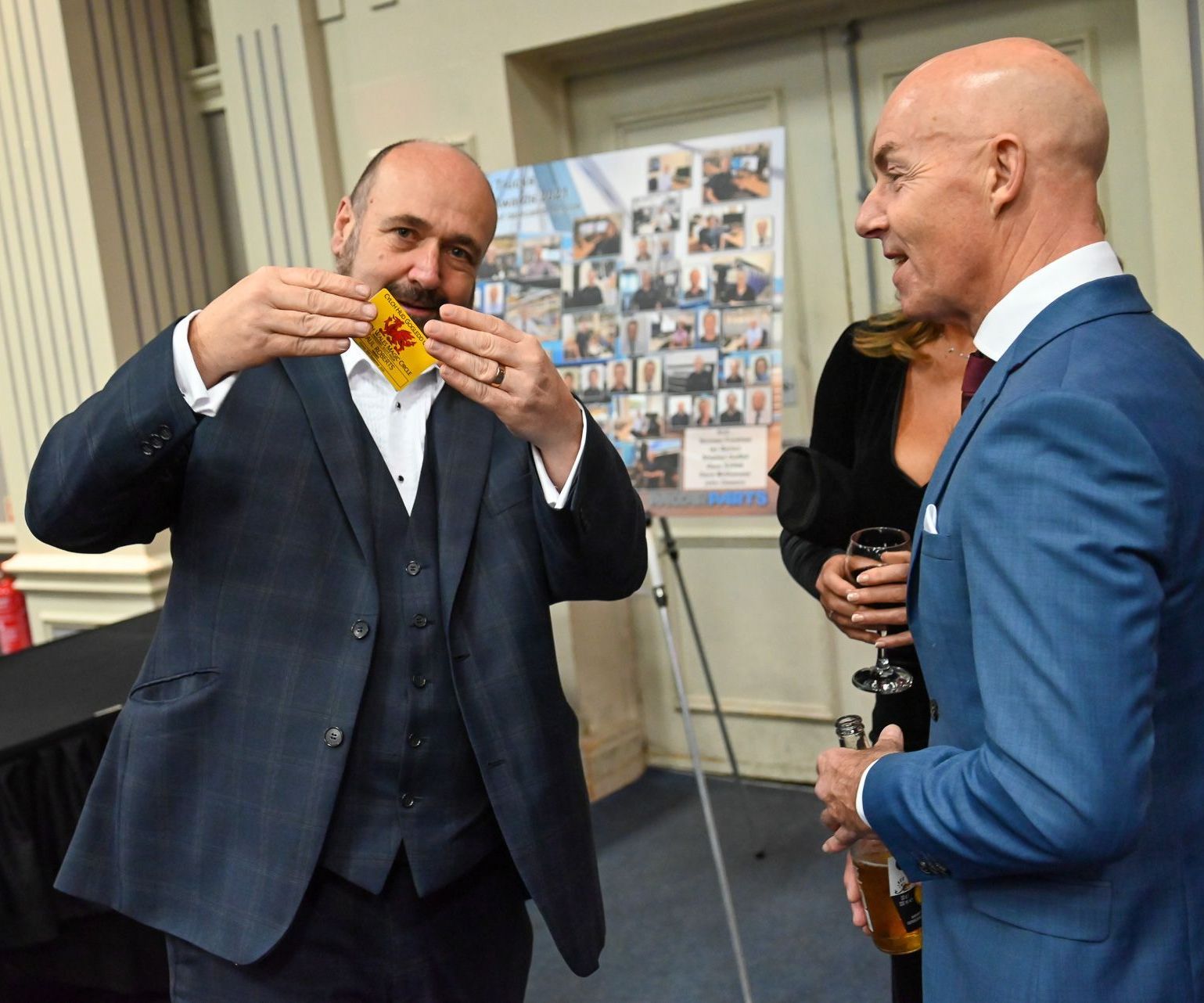 A businessman learning a magic trick during a sales meeting in Wrexham.