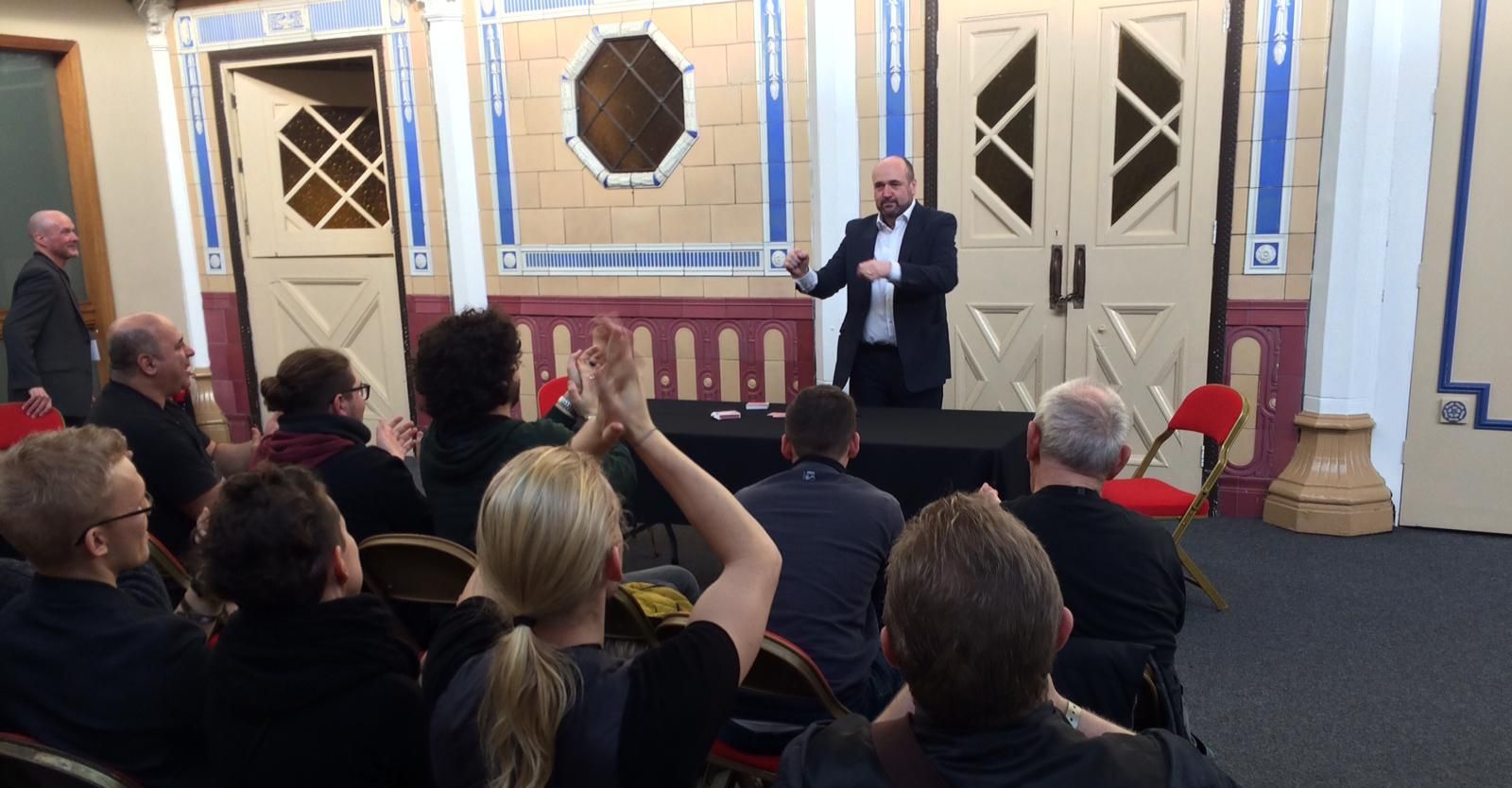 Paul Roberts lecturing to a group of magicians at a magic club event, showcasing his expertise as a magic instructor from Wrexham.