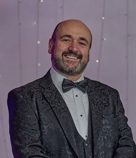 Paul Magician creating laughs and wonder.