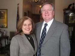 A man in a suit and tie is looking at the camera.