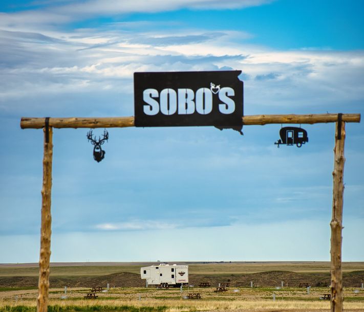 Sobos sign during the day with a beautiful blue Badlands sky.