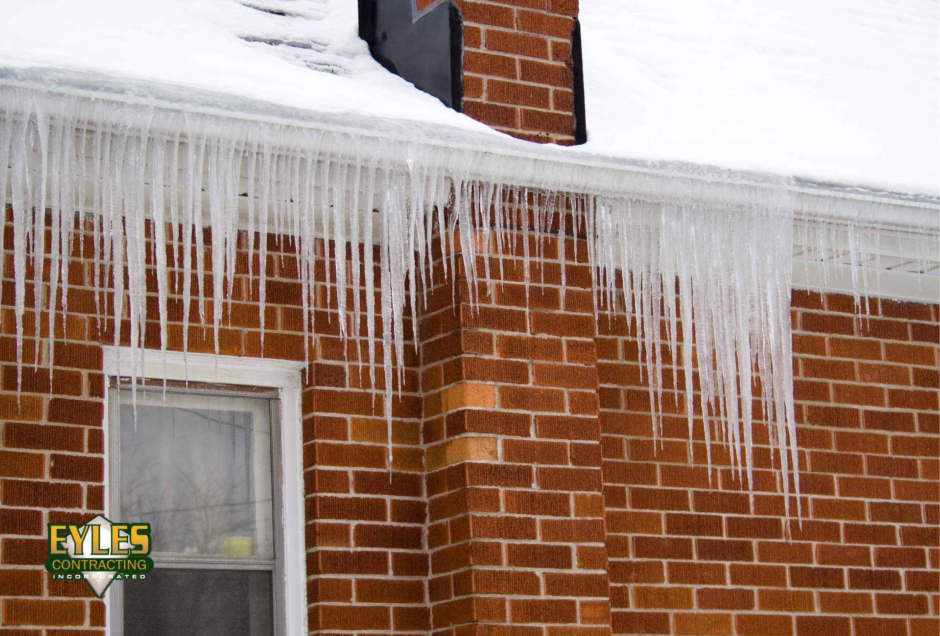 Home with icicles and ice build-up along the roof 