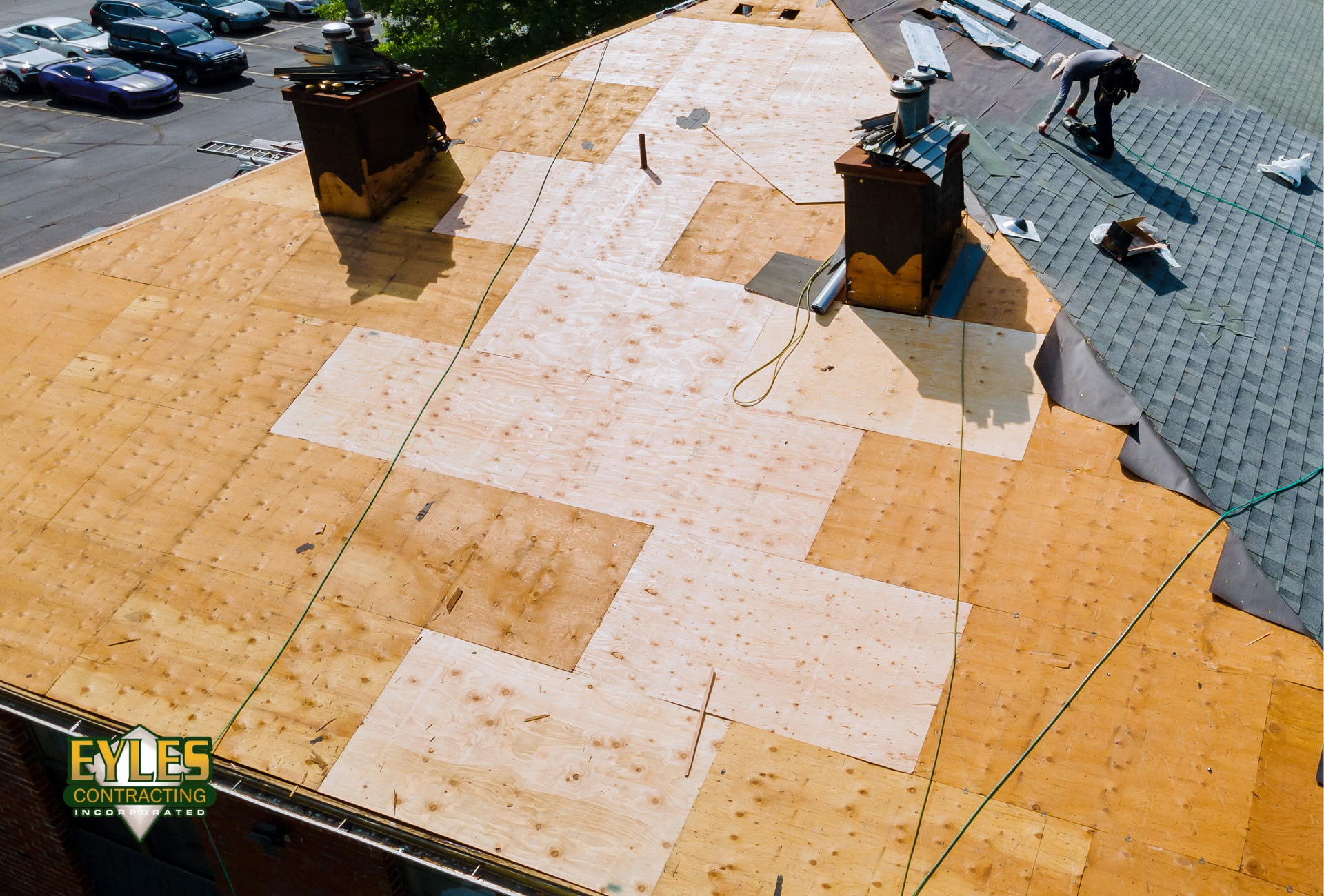 Roofing contractor installing roof decking on a commercial building
