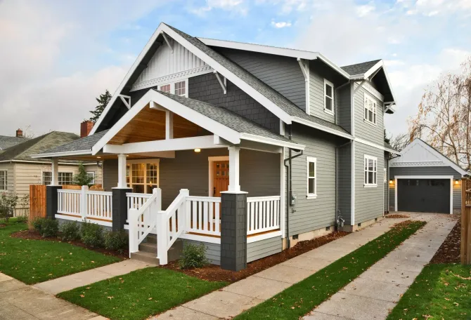 Eyles Contracting | A gray house with a white porch and a garage