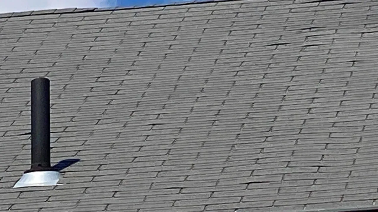 A close up of a roof with a chimney on it.