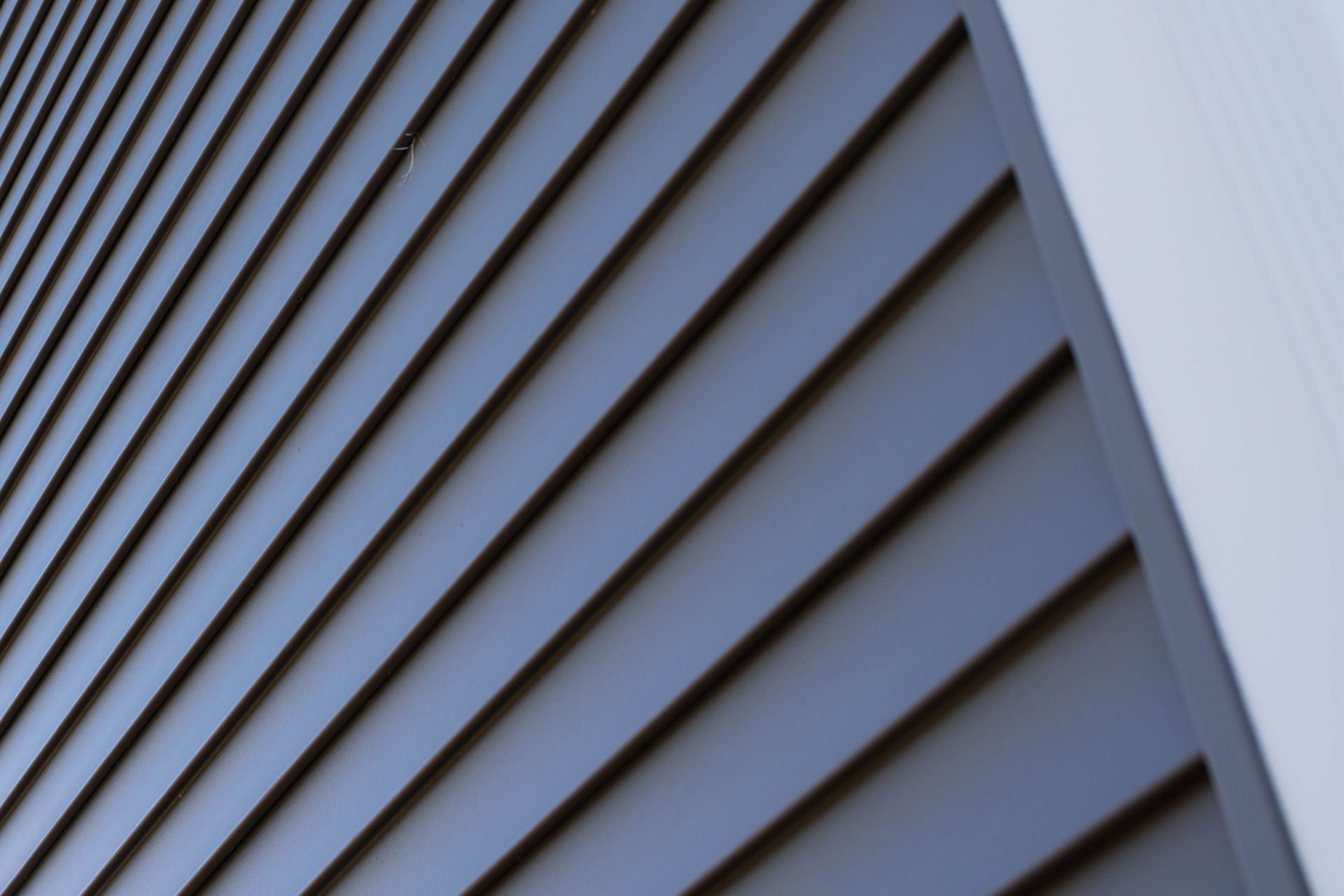 A close up of a blue siding on a building.