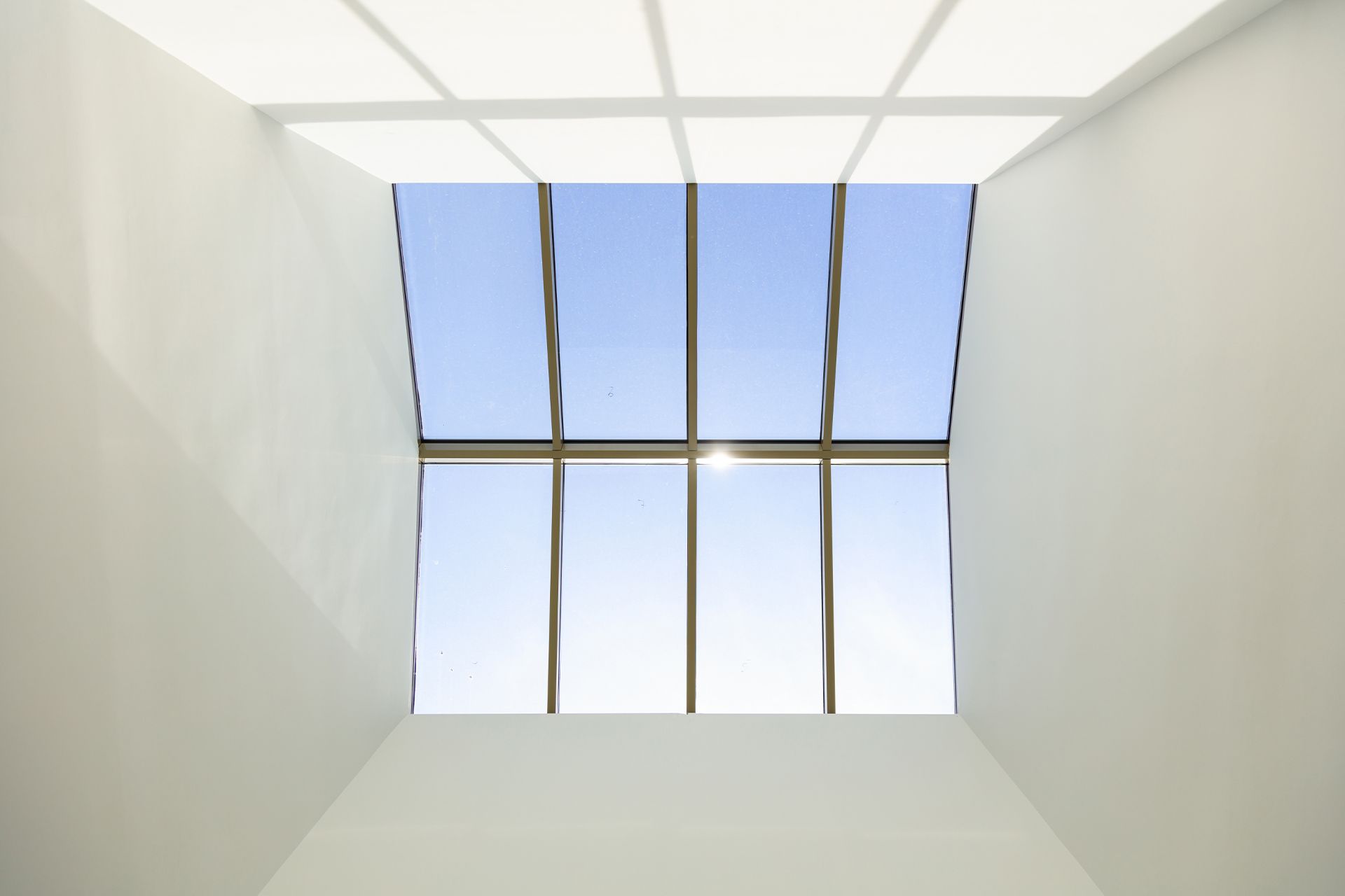 Eyles Contracting | Looking up at the sky through a skylight in a room.