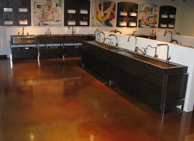 a kitchen with a lot of sinks and faucets