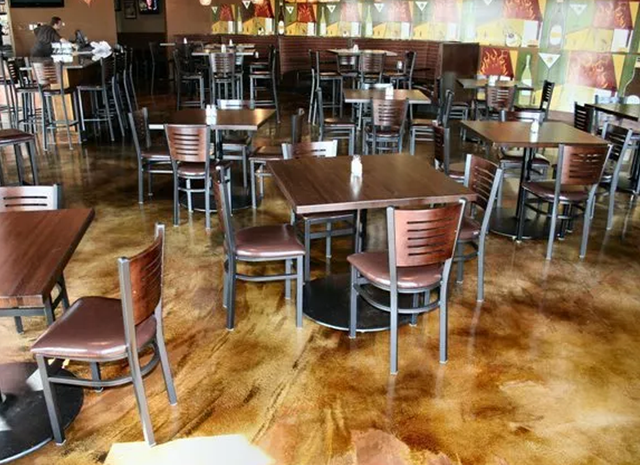 a restaurant with tables and chairs and a painting on the wall