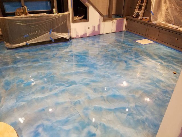 a blue and white metallic floor in a room with stairs .